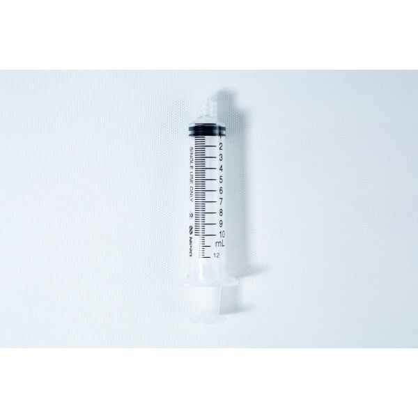 A clear plastic syringe with black measurement markings, placed on a white background.