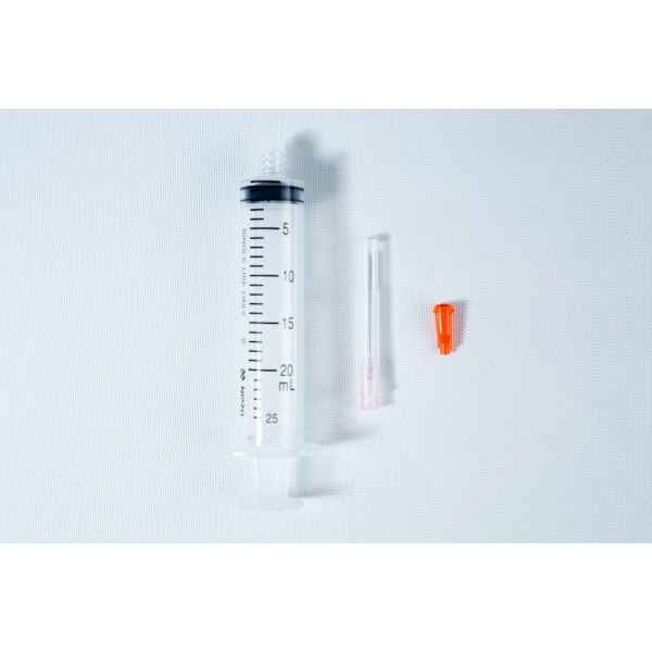 A 25 mL syringe, a needle, and an orange cap on a white background.