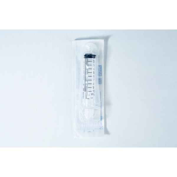 A sealed, sterile syringe in clear plastic packaging on a white surface.
