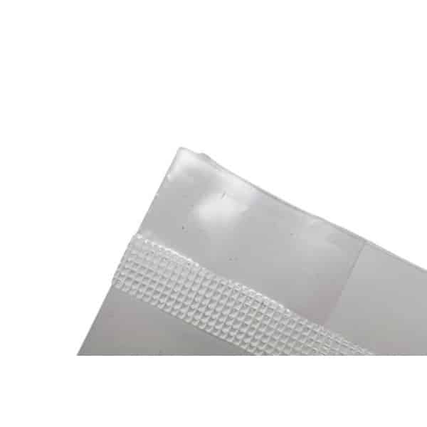 Close-up of the corner of a clear plastic bag with a textured sealing strip on a white background.