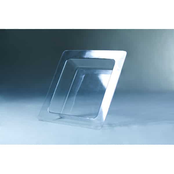 A square, transparent plastic tray with a raised rim, inspired by the Mycelium Mould Growth form - Paver (Reusable), sits elegantly on a light blue surface and background.