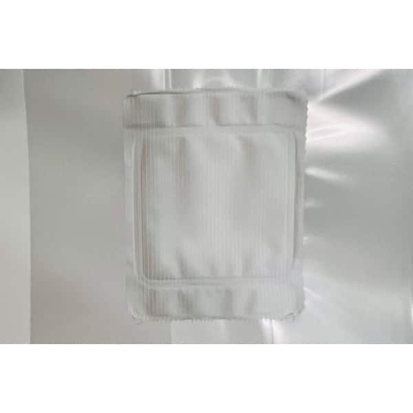 A white, square gauze pad is attached to a white, shiny surface.