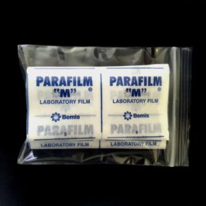 A packet of Parafilm Lab sealing film rolls is displayed in a clear plastic bag against a black background.