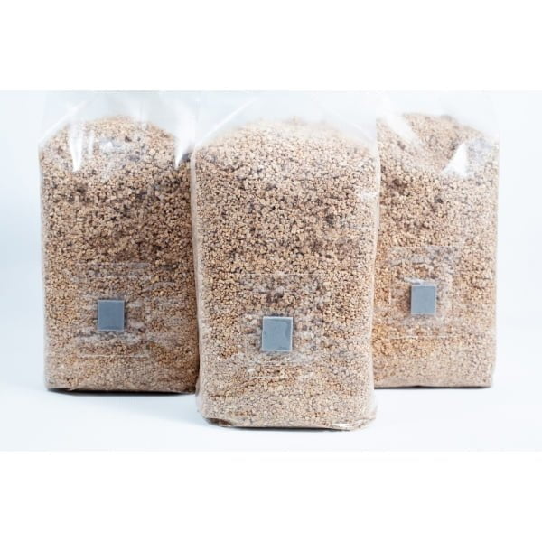 Three 1kg bags of organic brown rice flour (BRF) and vermiculite for PF Tek mushroom cultivation stand upright on a white background.