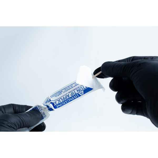 Gloved hands opening a blue antiseptic towelette packet with a cotton bud and the Agar petri dish MEA School Science Fun Project Kit nearby, set on a white background—ideal for school science experiments.