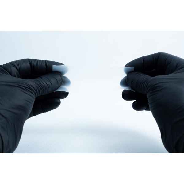 Two gloved hands pull apart a piece of translucent material from the Agar petri dish MEA School Science Fun Project Kit—a classic moment in school science experiments against a white background.