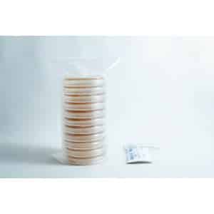 A stack of pre-poured MEAG agar plates (antibacterial) 90mm, sealed in plastic, sits next to a small packet on a white surface.
