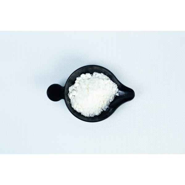 A black bowl containing Antibacterial Powder for mushroom cultivation sits on a white textured surface.