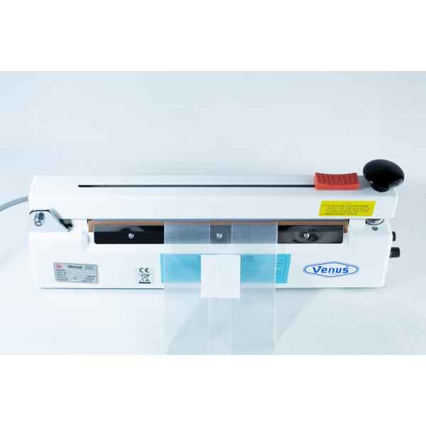 A Heat Sealer 30cm Seal Width 5mm with cutter and magnet in white is shown from above with a plastic bag placed in the sealing area.