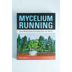 The cover of "Mycelium Running: How Mushrooms Can Help Save the World" by Paul Stamets features a forest and mushrooms—an essential mycology book for enthusiasts.
