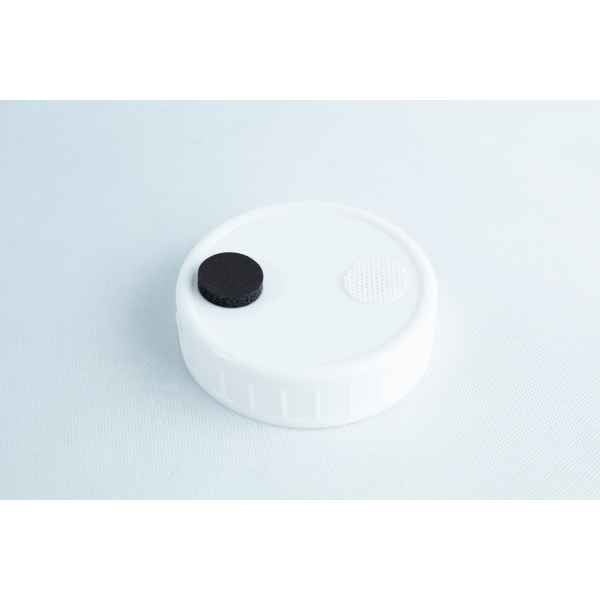 The Self-healing injection port & Air Vent Filter-3M features a white plastic cap with a black circle and textured white circle on top, designed for secure injections and air venting. Shown against a light background.