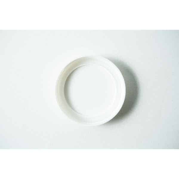 A Mason Jar Lid (Plain White Plastic, Wide Mouth 86mm) from "Mason Jar Lids" rests on a lightly textured surface, viewed from above.