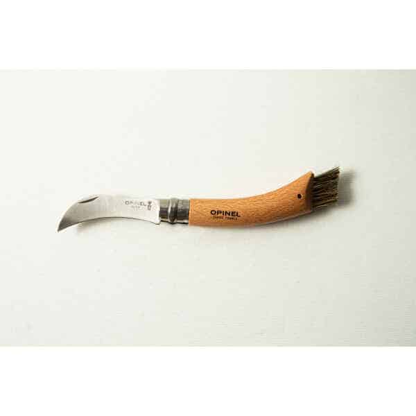 The Opinel No 8 Folding Mushroom Knife features a stainless steel blade, a beechwood handle, and a small brush—ideal for foraging and cleaning mushrooms.