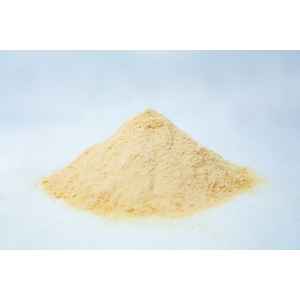 A small mound of fine, light yellow Mycological Soya Peptone powder for agar media use in microbiology labs rests on a white surface against a soft, blurred background.