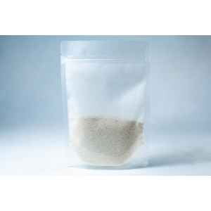A clear resealable plastic pouch containing Natural Gypsum coarse grade—white granules used as a mushroom supplement for grain and substrate—stands upright on a light background.
