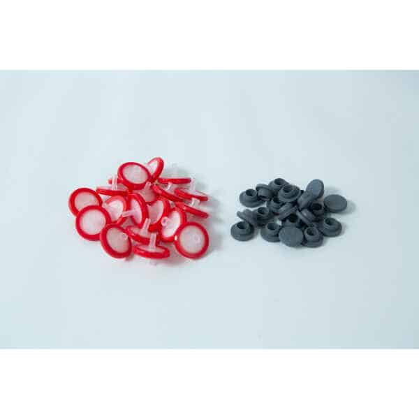A set of Rubber Self-Healing Injection ports and red-and-white PTFE Syringe Filters for Mycology are arranged together on a white surface.