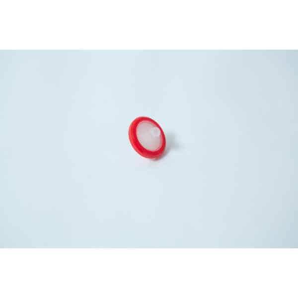The Rubber Self-Healing Injection Port and Syringe Filter PTFE for Mycology, featuring a round red plastic body with a white centre and injection port, is displayed on a plain white background.