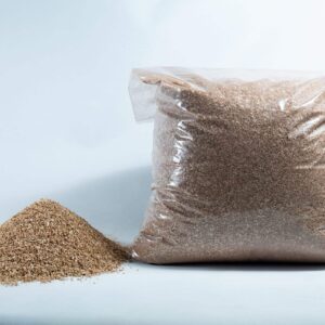 A clear plastic bag labelled "Vermiculite, Grade 2, fine, mycology" sits beside a small pile of brown grains on a white background.