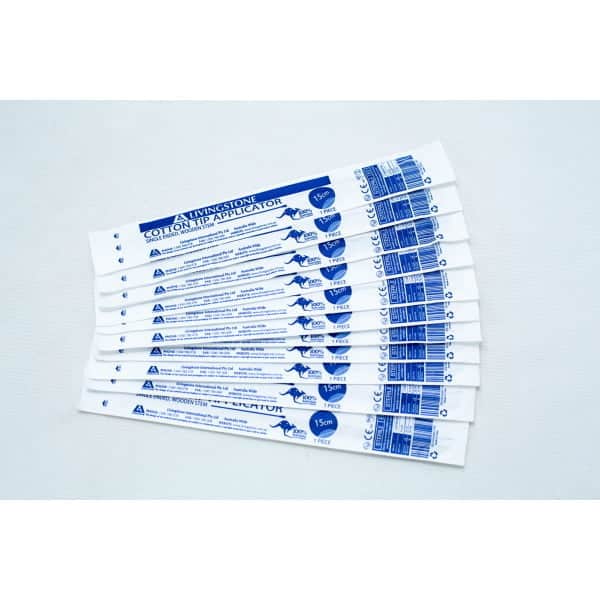 Ten packaged sterile cotton tip applicator/swab are fanned out on a white surface.