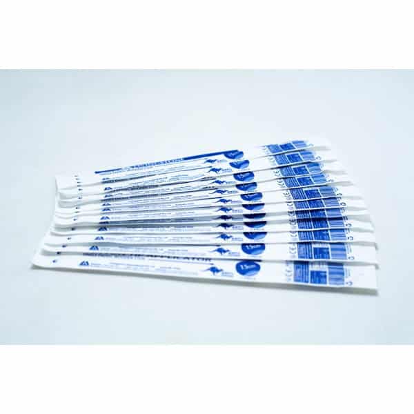 Several individually wrapped sterile cotton bud products in white and blue packaging are arranged on a white surface.