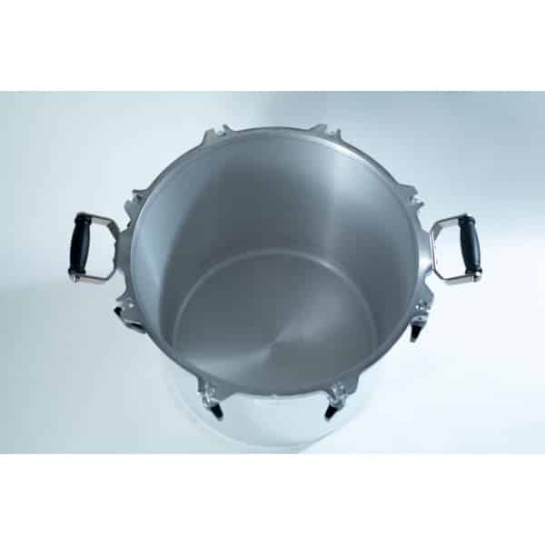 Top view of an empty stainless steel pressure cooker with black handles on a white surface.