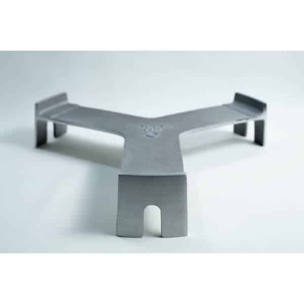 Metal trivet with three legs and a flat, Y-shaped design on a plain white background.