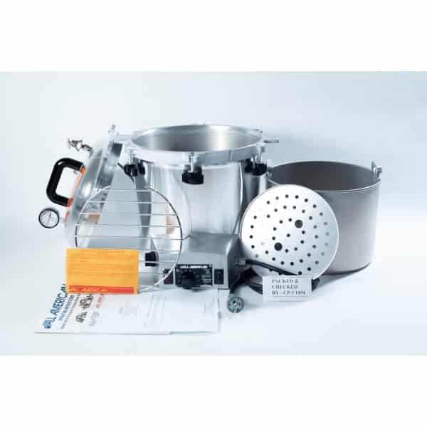 Parts of a pressure canner, including pot, lid, racks, gauge, and instruction leaflets, arranged on a white background.