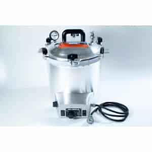 Silver pressure cooker with gauge, handle, power lead, and control knob on a white background.