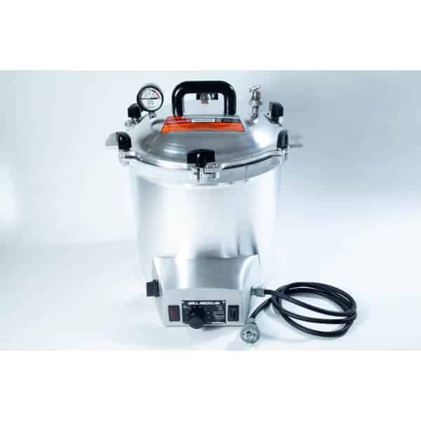 Silver pressure cooker with gauge, handle, power lead, and control knob on a white background.