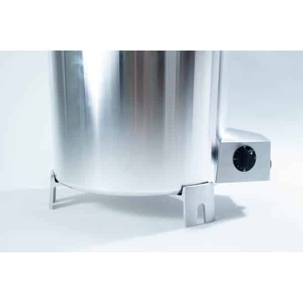 Close-up of a shiny stainless steel appliance with a black dial, shown on a white background.
