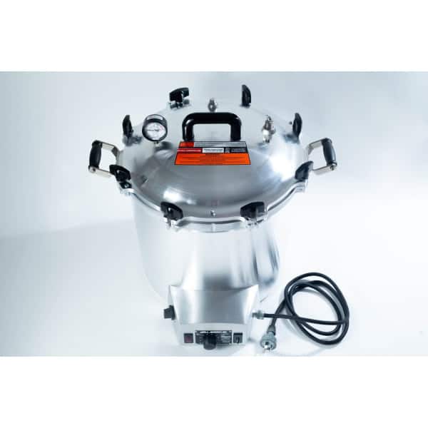 Large stainless steel pressure cooker with a gauge, black handles, and an attached power lead.
