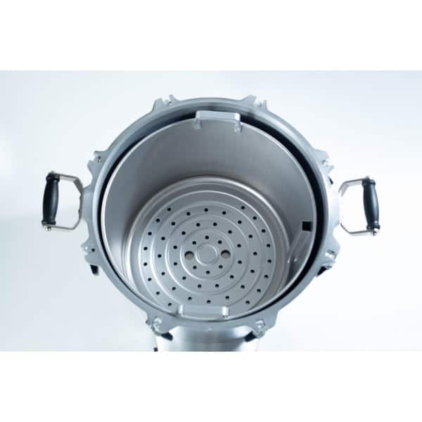Top view of an empty stainless steel pressure cooker with black handles and a perforated steamer insert.