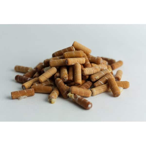 A pile of Log Dowel Mushroom Plug Spawn—Native Australian Reishi (Ganoderma steyaertanum) pellets is shown on a white surface.