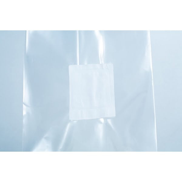 A small white adhesive plaster on a clear plastic surface, perfect for use with Millet pre-sterilised mushroom grains w/injection port and digital instructions.