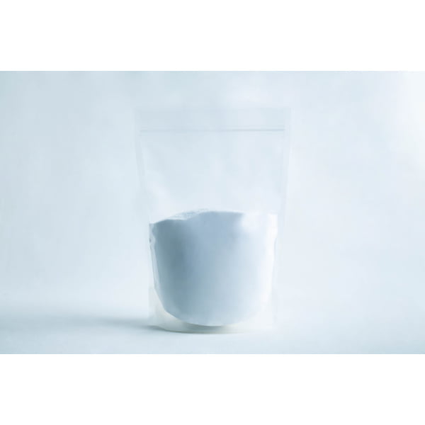 A clear resealable pouch filled with white powder, set against a plain white background.