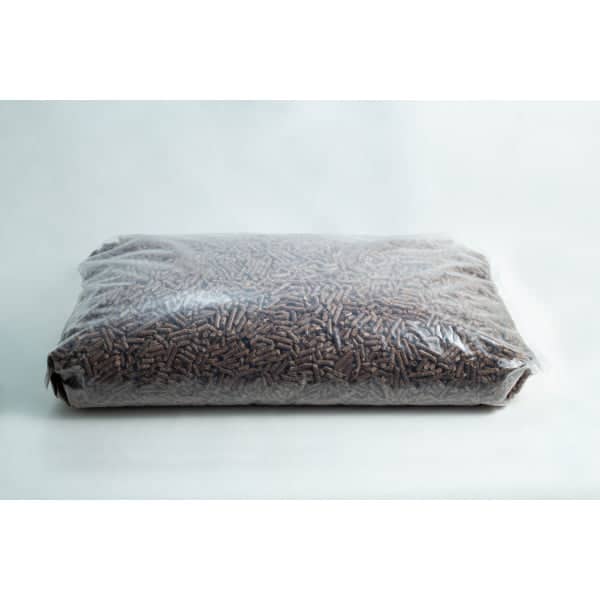 A sealed plastic bag filled with brown wood pellets on a plain white background.