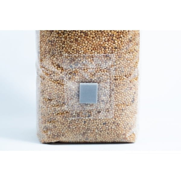 A clear plastic bag of millet pre-sterilised mushroom grains with injection port and digital instructions, sealed with a grey square label.