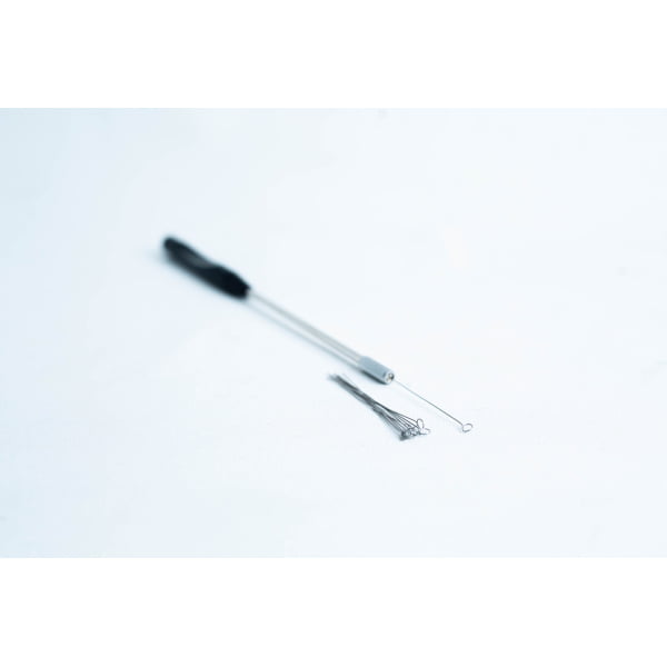 Close-up of a metal inoculating loop tool and spare loops on a white surface.