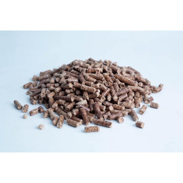 A pile of brown cylindrical wood pellets on a white surface.