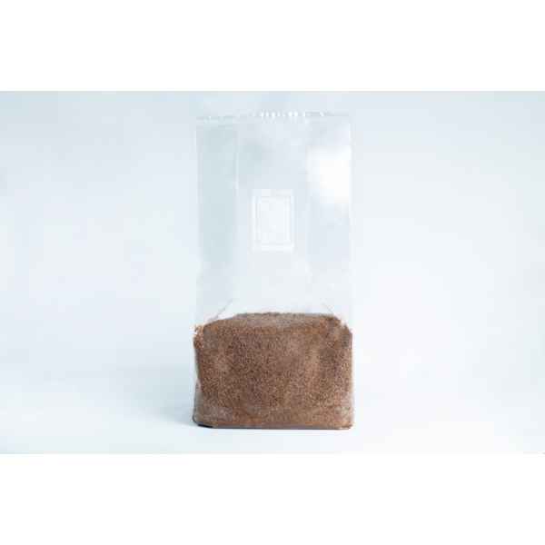 A clear plastic bag, filled halfway with brown granules of Masters Mix Mushroom Substrate Sawdust and Soya Pellets, is pictured against a white background.