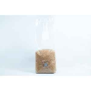 A clear plastic bag of Millet Pre-Sterilised Mushroom Grains with injection port and digital instructions, sealed at the top, shown on a white background.