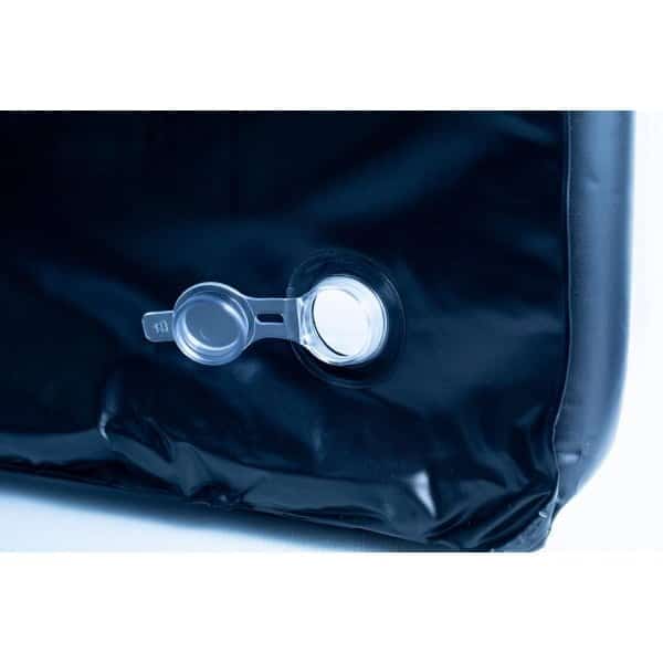 Close-up of an air valve on a black inflatable object, with a transparent plastic cap.