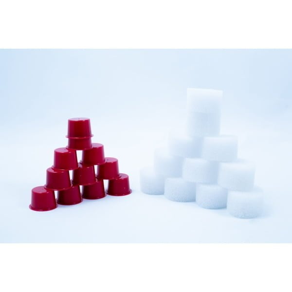 Red plastic cups and white cylindrical sponges are stacked in pyramid shapes on a white background.