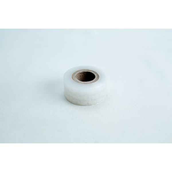 A single roll of "Grafting Tape to seal agar plates or for plant grafting" rests on a plain white surface, perfect for sealing agar plates or use in plant grafting.