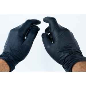 Two hands wearing black disposable gloves are held up against a plain white background, suggesting readiness for hygienic tasks often paired with a Disposable Face Mask/Unit Individually wrapped.