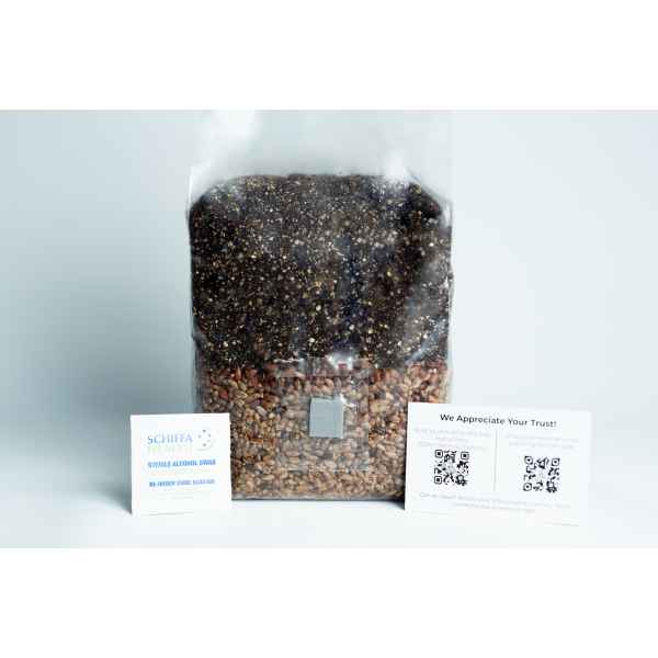 A clear bag of grains with two information cards beside it on a white surface.