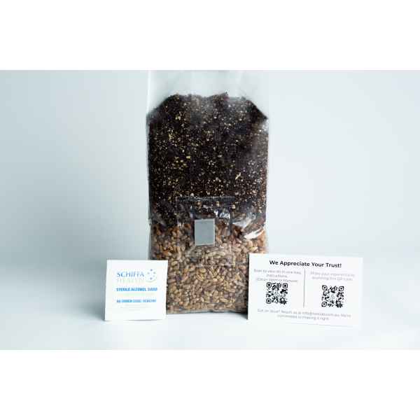 A sealed bag of seeds and soil with two informational cards displayed in front of it on a white surface.