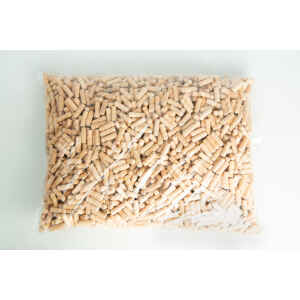 A clear plastic bag filled with small, cylindrical wooden pegs on a white surface.