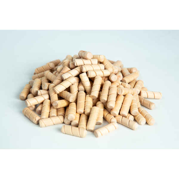 A pile of small, light wooden dowels on a white surface.