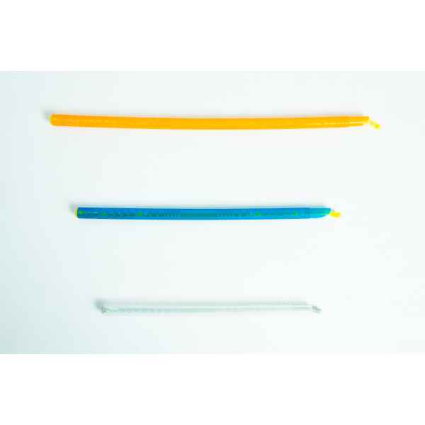 Three colourful twist ties, orange, blue, and clear, are laid out horizontally on a white background.